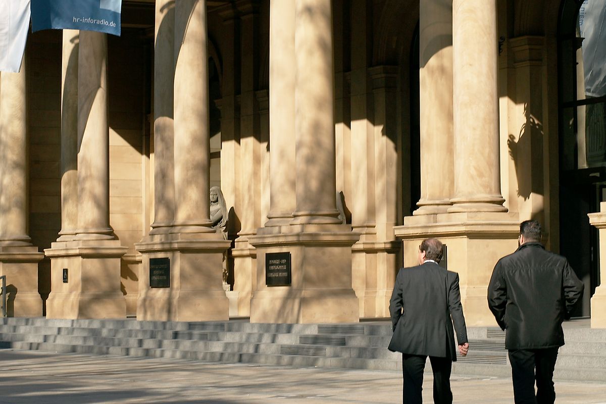 Stock Exchange building with flags and passersby